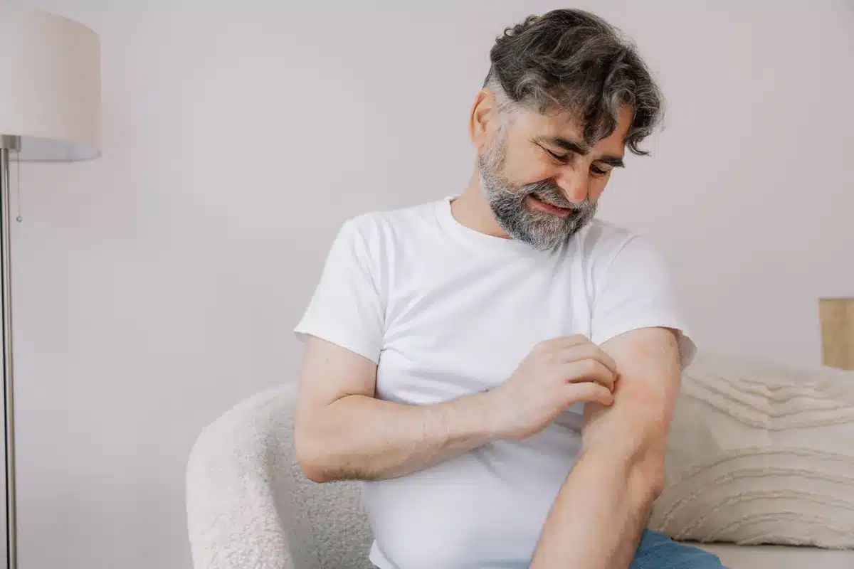 Homme qui se gratte à cause des puces